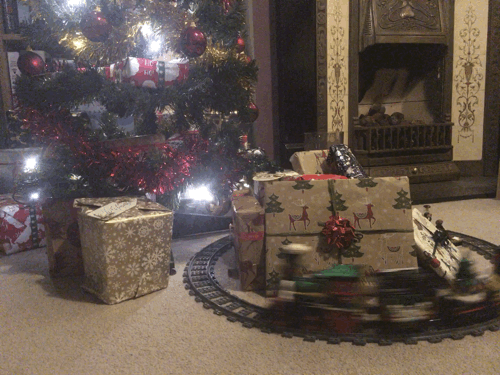 A model train, some presents and a christmas tree